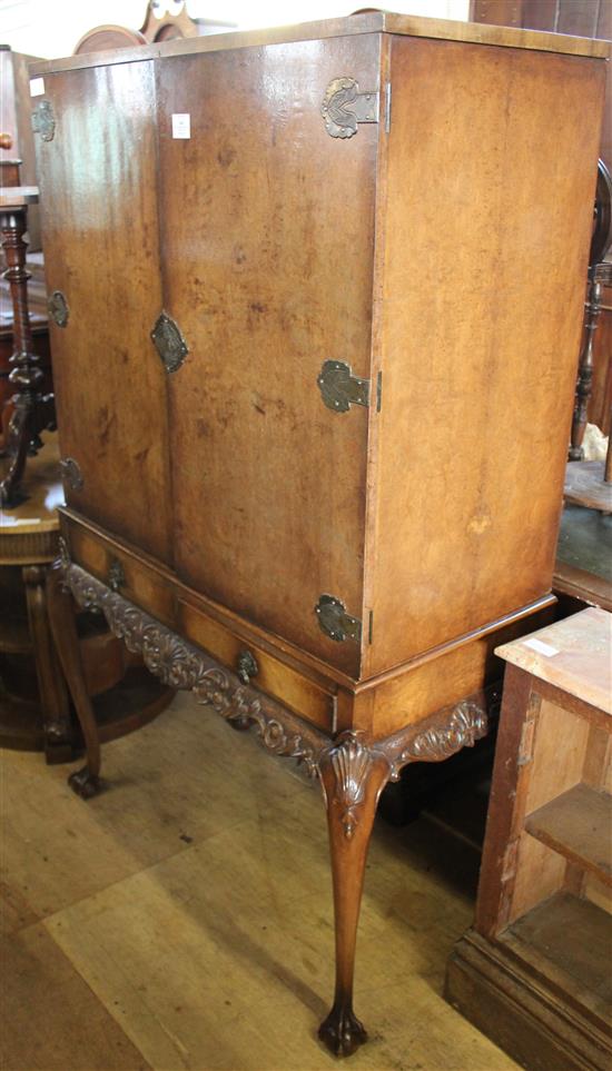 Walnut drinks cabinet on carved stand
